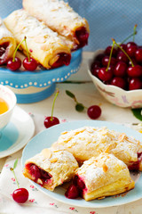 Pies from puff pastry with cherry