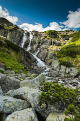 Fototapeta na wymiar Natural waterfall in high mountains