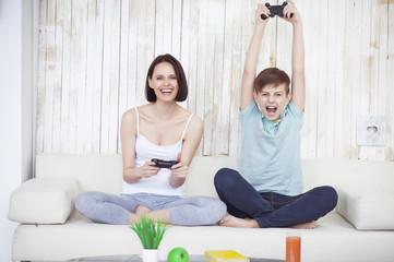 Mother and her adult son playing on console