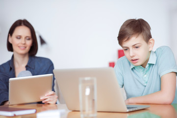 Boy using laptop at home