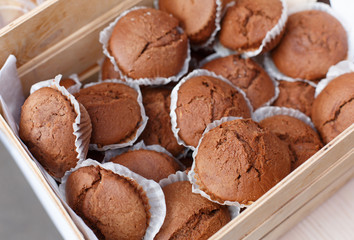 Chocolate muffins closeup in wooden tray