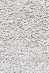 White roughcast lime mortar plaster wall background texture on an old building made from sand and...