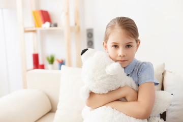 Fototapeta premium Little girl holding teddy bear