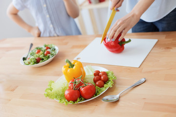 Mother and daughter making salad
