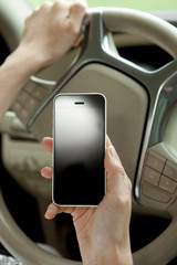 transportation and vehicle concept - woman using phone while driving the car