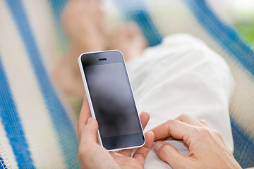 relaxing on hammock with a smartphone
