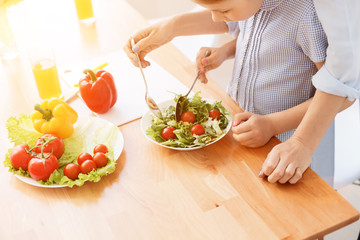 Mother and daughter making salad