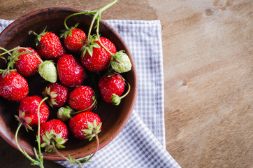 Fresh ripe organic strawberry on wooden background. Rustic style.