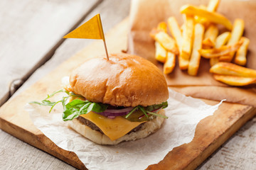Delicious homemade hamburger with french fries on wooden vintage table