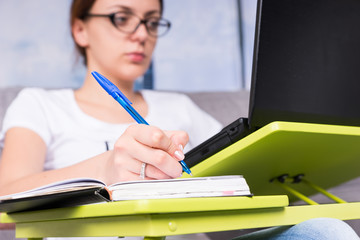 Close up of hand of a  young woman who working on a laptop from