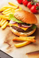 Delicious homemade hamburger with french fries on wooden vintage table