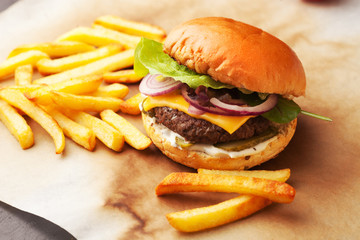 Delicious homemade hamburger with french fries on wooden vintage table