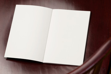 Blank spread, open book on old wooden table.