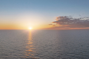 Incredible orange sunrise over the baltic sea with a warm breeze