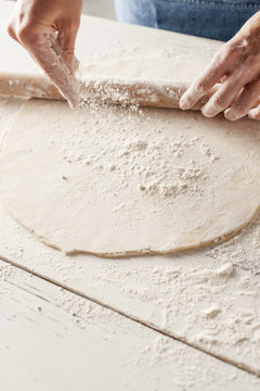 Sprinkling flour onto rolled out pastry