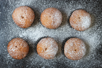 muffins in powdered sugar on a dark