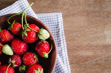 Fresh ripe organic strawberry on wooden background. Rustic style.