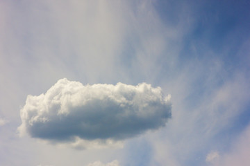 Blue sky with puffy white cloud in bright clear sunny day