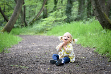 Happy little girl in the wood