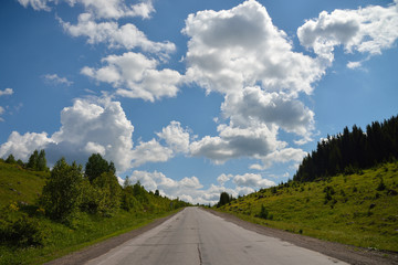 scenic view to the road in mountains with beautiful sky