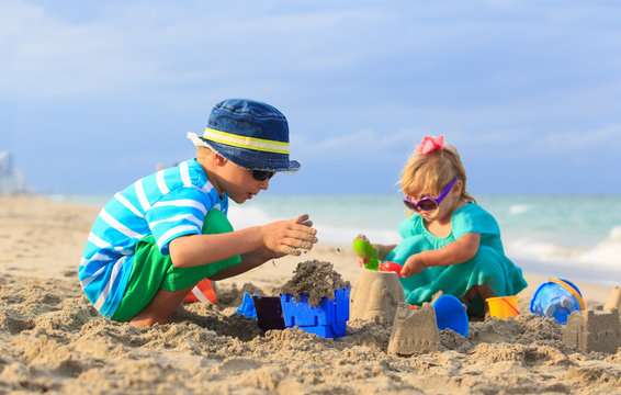 Kids Play With Sand On Summer Beach