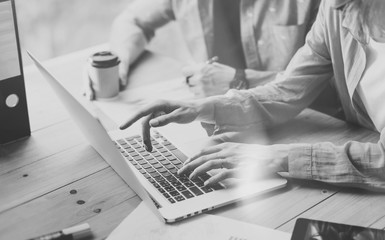 Sales Department Working Modern Design Loft.Woman Showing Market Report Charts Laptop.Marketing managers Planning New Strategy.Researching Process Wood Table.Horizontal.Blurred Background.Black White.