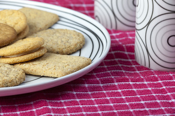 Plate of biscuits and cups on a red napkin