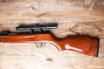 Air rifle isolated on wooden background