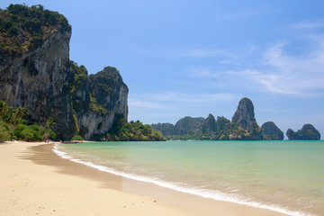 Fototapeta na wymiar Beach with palm trees and rocks in the south of Thailand