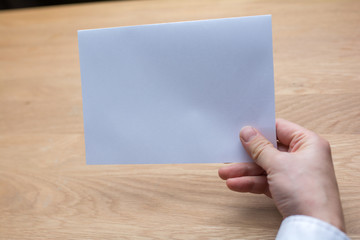 Fototapeta premium businessman holding white blank paper