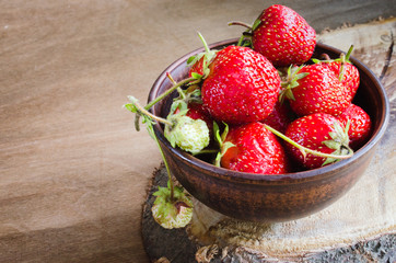 Fresh ripe organic strawberry on wooden background. Rustic style.