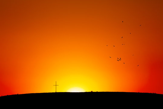Cross on hill in Sunset/Sunrise