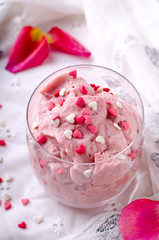 Strawberry dessert in glasses and pink rose, decorated with sugar hearts. Valentines Day background