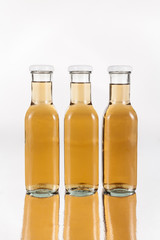 glass bottles with drink on neutral background