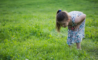 one little girl with magnifying glass outdoors in the day time