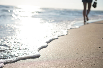 Silhouette of a girl walking on the beach. out of focus.
