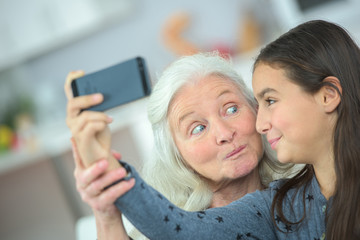 Grandma and girl taking a photo of themselves