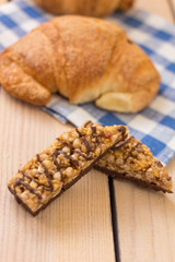 fresh pastries on a wooden background. blue napkin. croissant