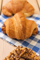 fresh pastries on a wooden background. blue napkin. croissant