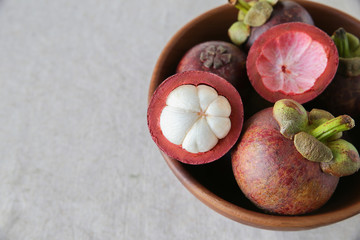 Mangsteen in wooden fruit bowl, copy space background
