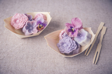 Pastel pink purple flower coconut jelly on bamboo serving boat,toning