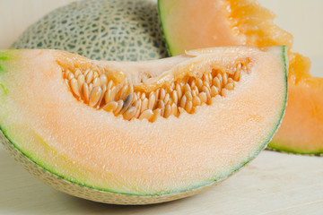 Sliced melon with seed on wooden board (Other names are Melon, c