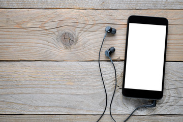 Smartphone with headphones on wooden background - Powered by Adobe