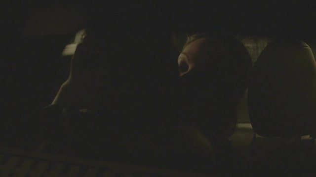 Beautiful young couple kissing passionately on backseat of car