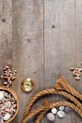 Travel items on wooden table. rope compass and seashells mock-up