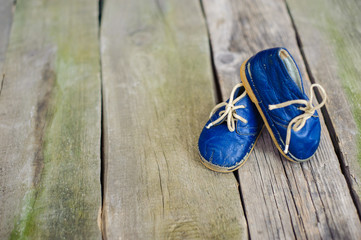 Vintage boot on wood, retro background.