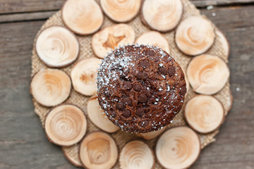 Chocolate muffin on a wooden stand