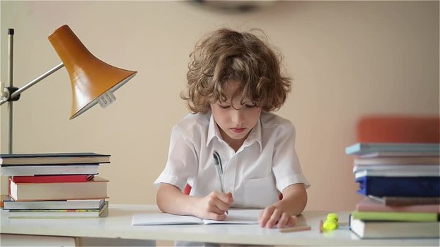 A child of primary school age do homework. Boy did homework and went for a walk