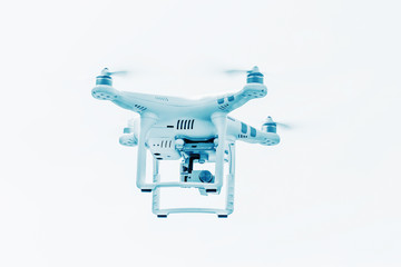 White drone with lights, quadrocopter with photo camera flying i