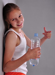 portrait of young sportive teen girl with a bottle of drinking water